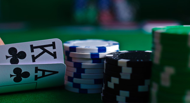 Poker cards and chips on a green area